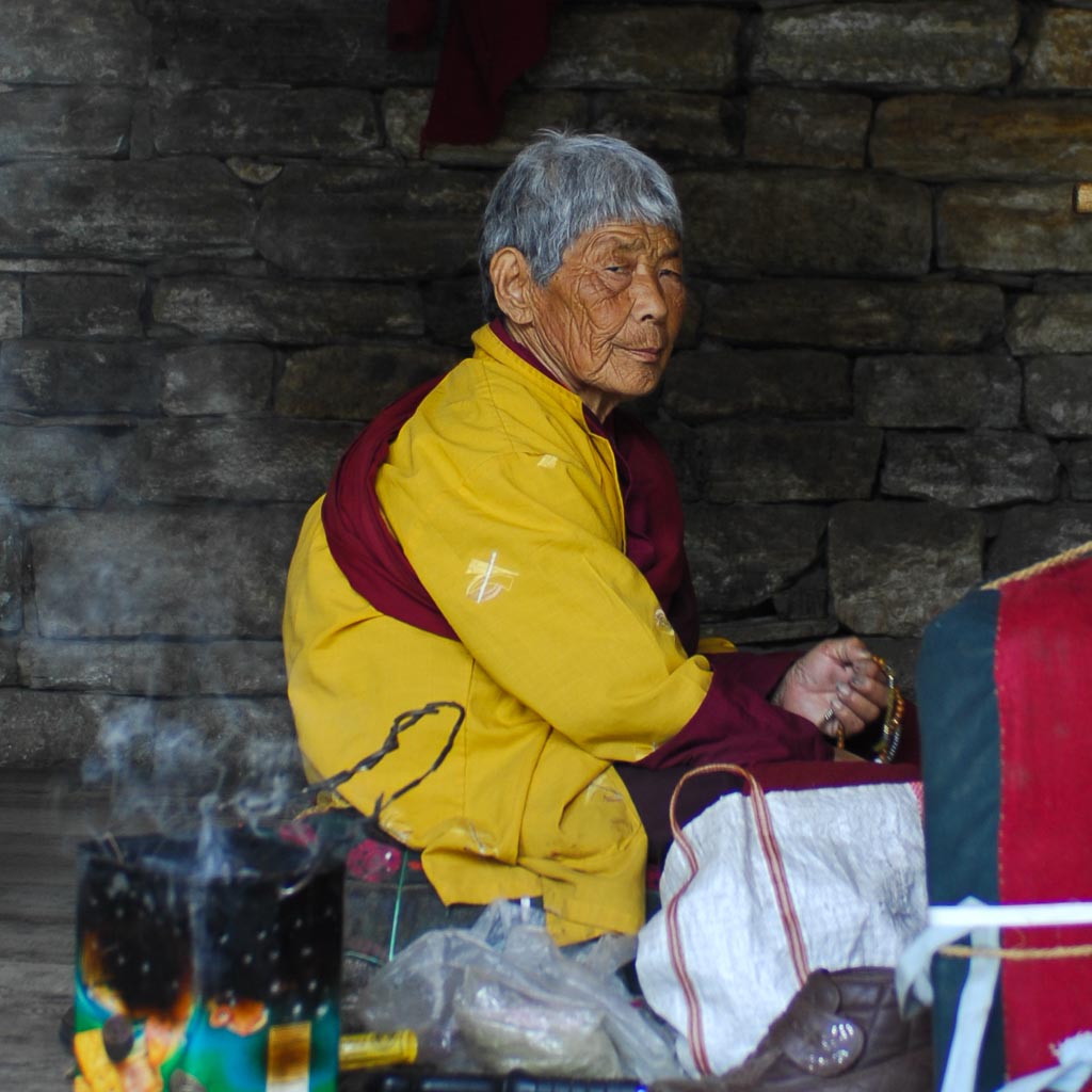 Old woman at prayer mills, National Memorial Stupa in Thimphu, Bhutan