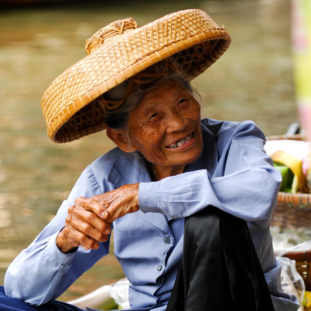 Old woman on floating market, Damnoen Saduak, Thailand