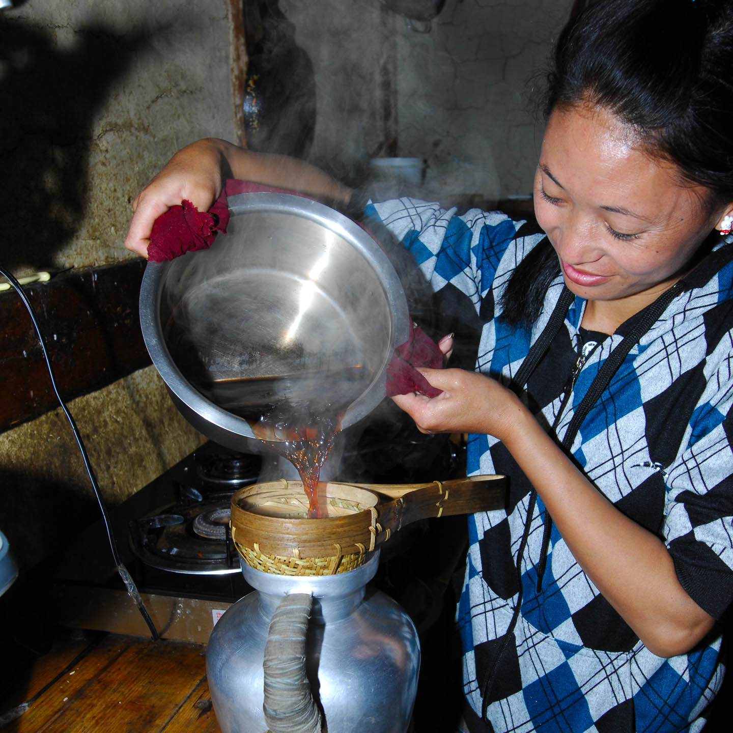 Being visiting with a farmer's family - Preparing traditional butter-tea